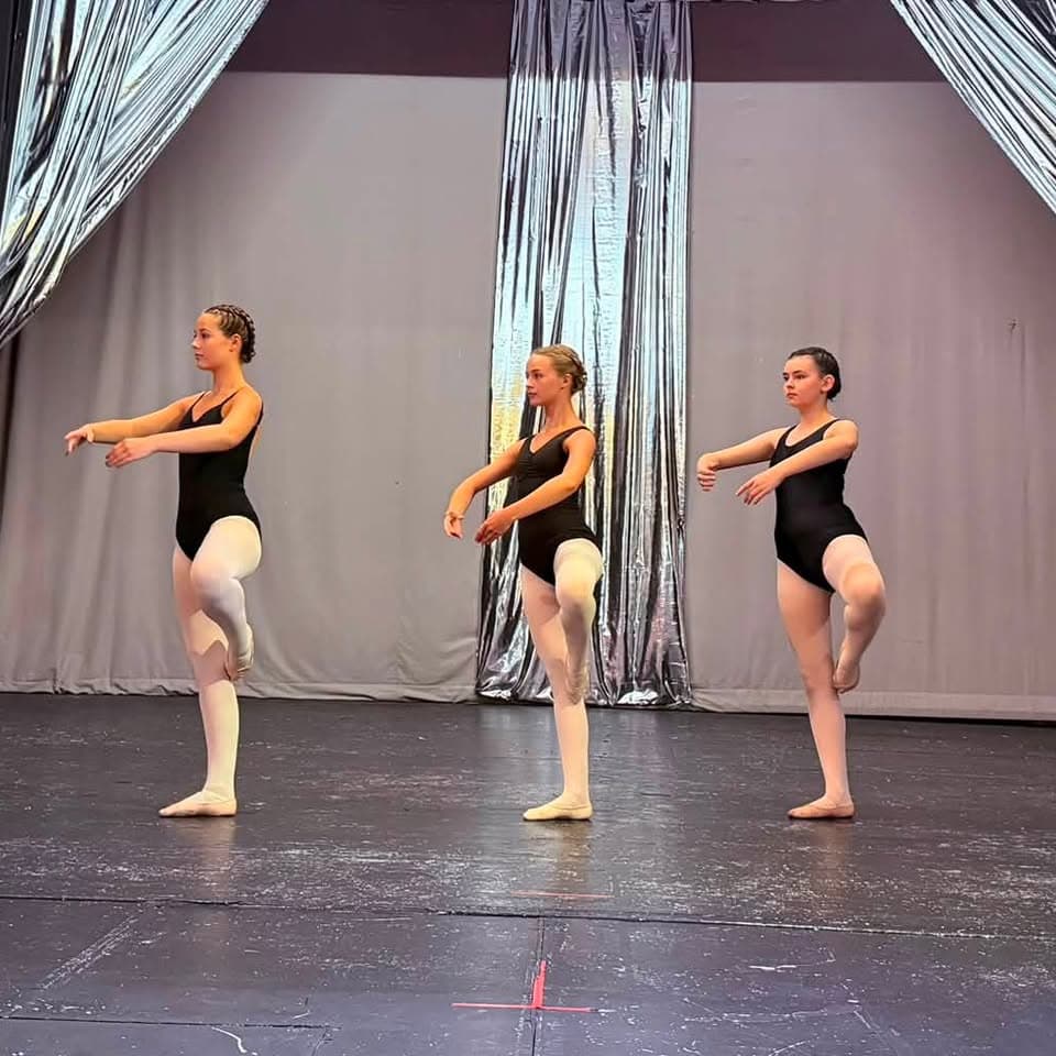 Three young ballet dancers in retiré