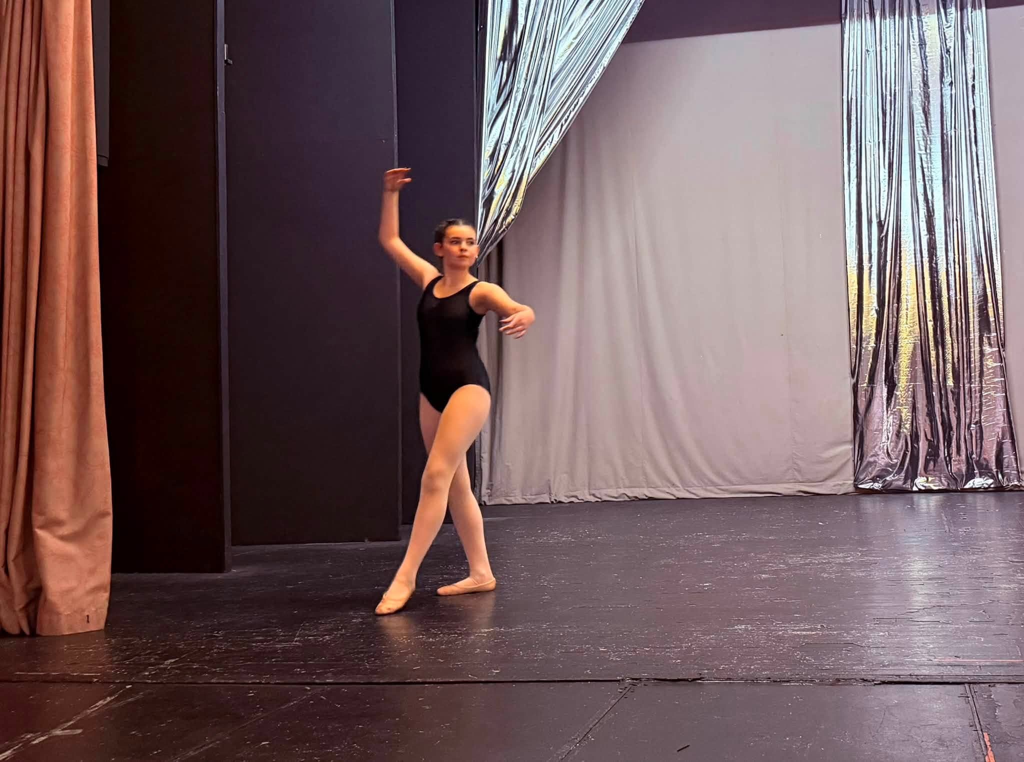 Young ballet student in a stage pose